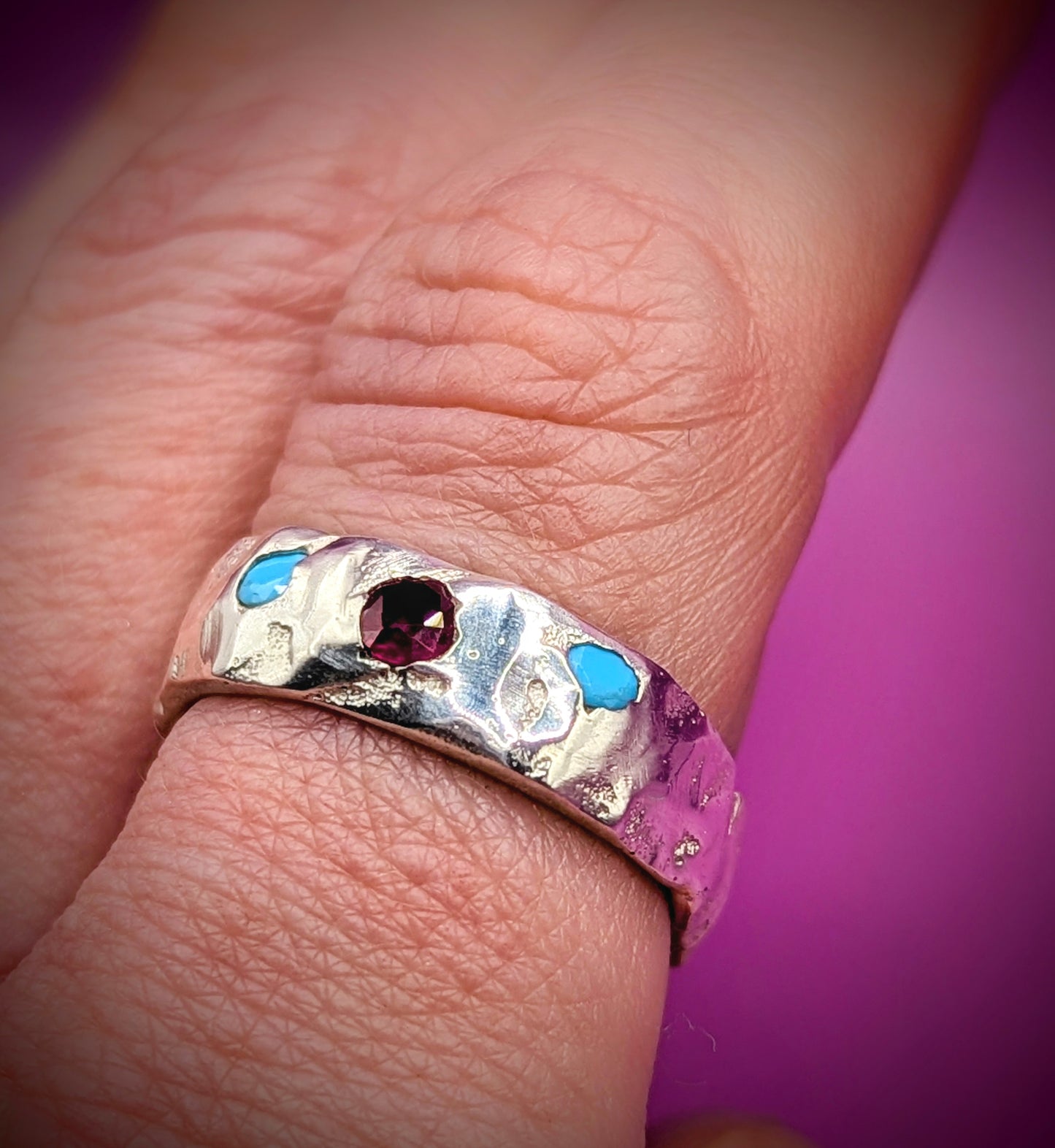 Organic sandcast silver ring with red and blue stones – expressive ethical jewellery UK