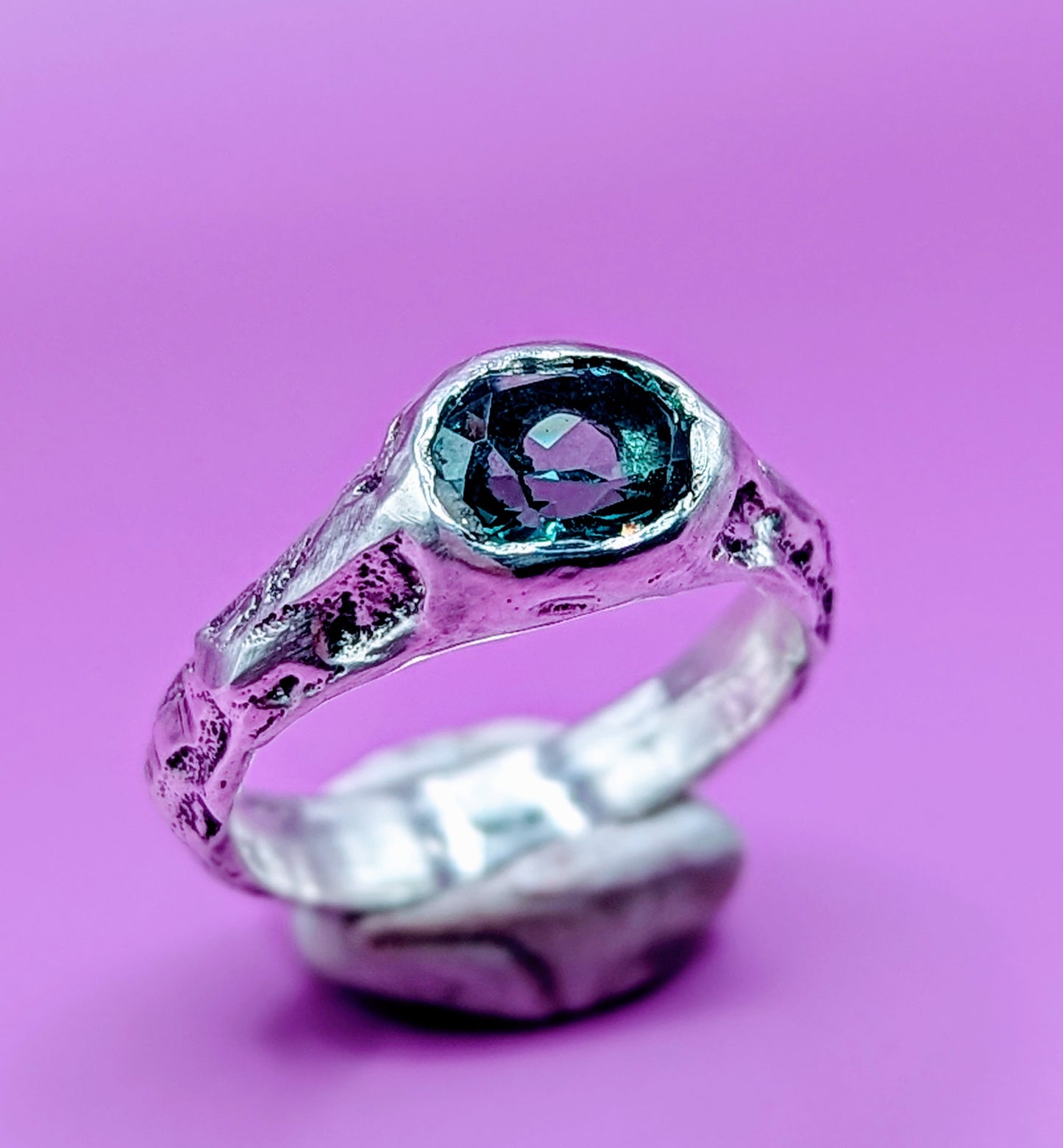 Handmade sandcast silver ring with colour-shifting Alexandrite – raw textured band