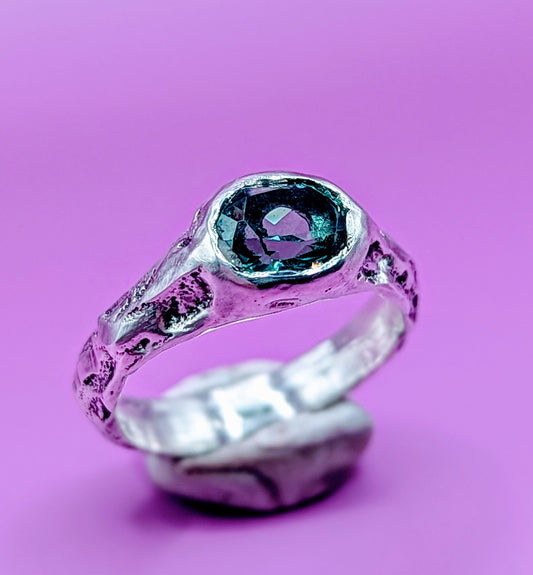 Handmade sandcast silver ring with colour-shifting Alexandrite – raw textured band