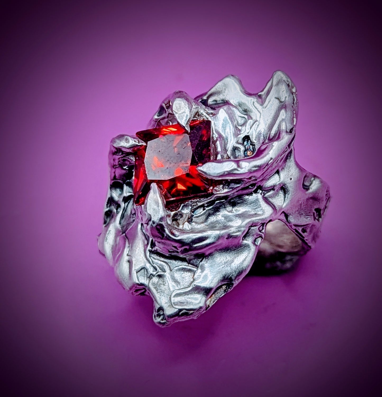 Handmade lost wax silver ring with lab-created red garnet – bold molten claw design