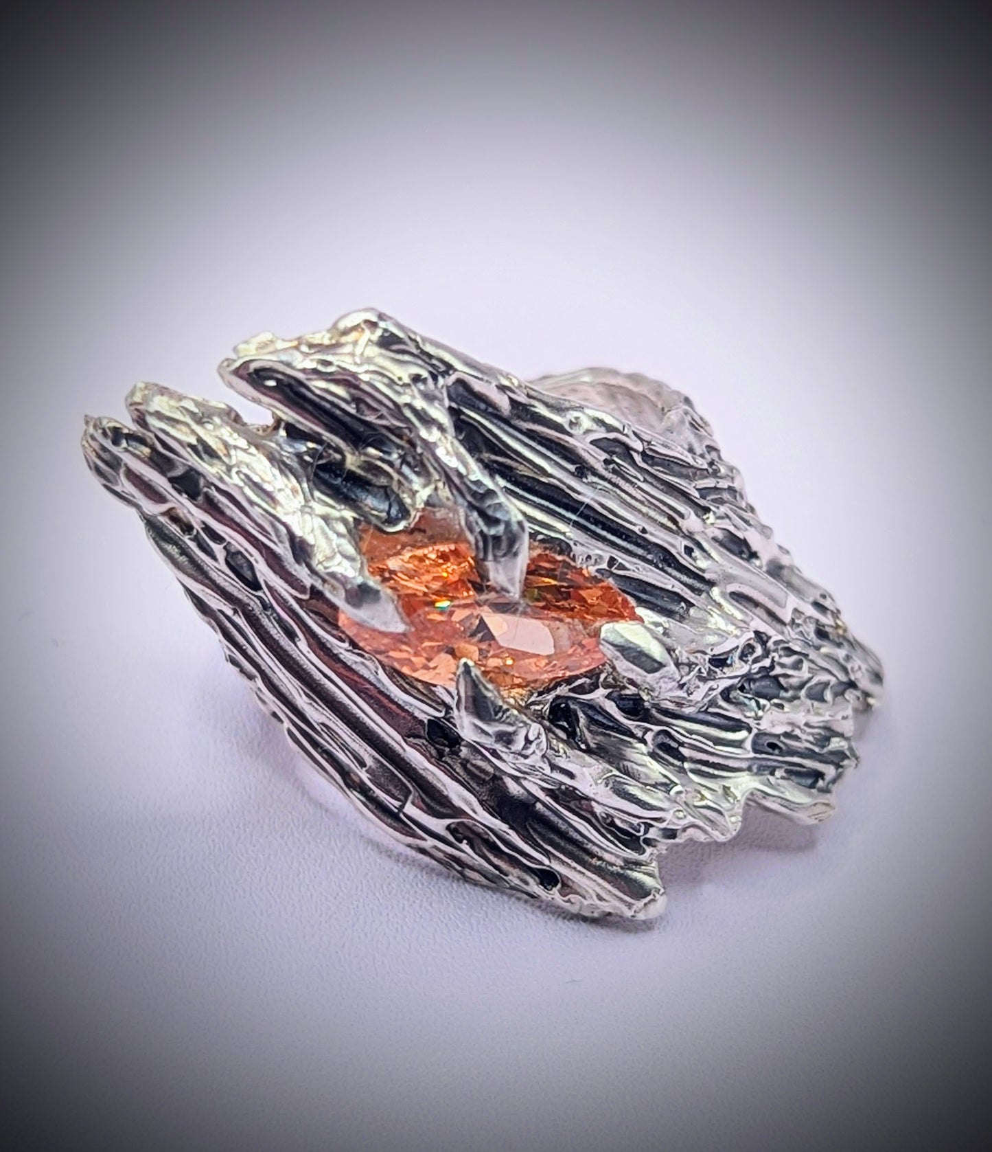 Sculpted silver ring inspired by tree bark – handmade with dark patina and warm gem
