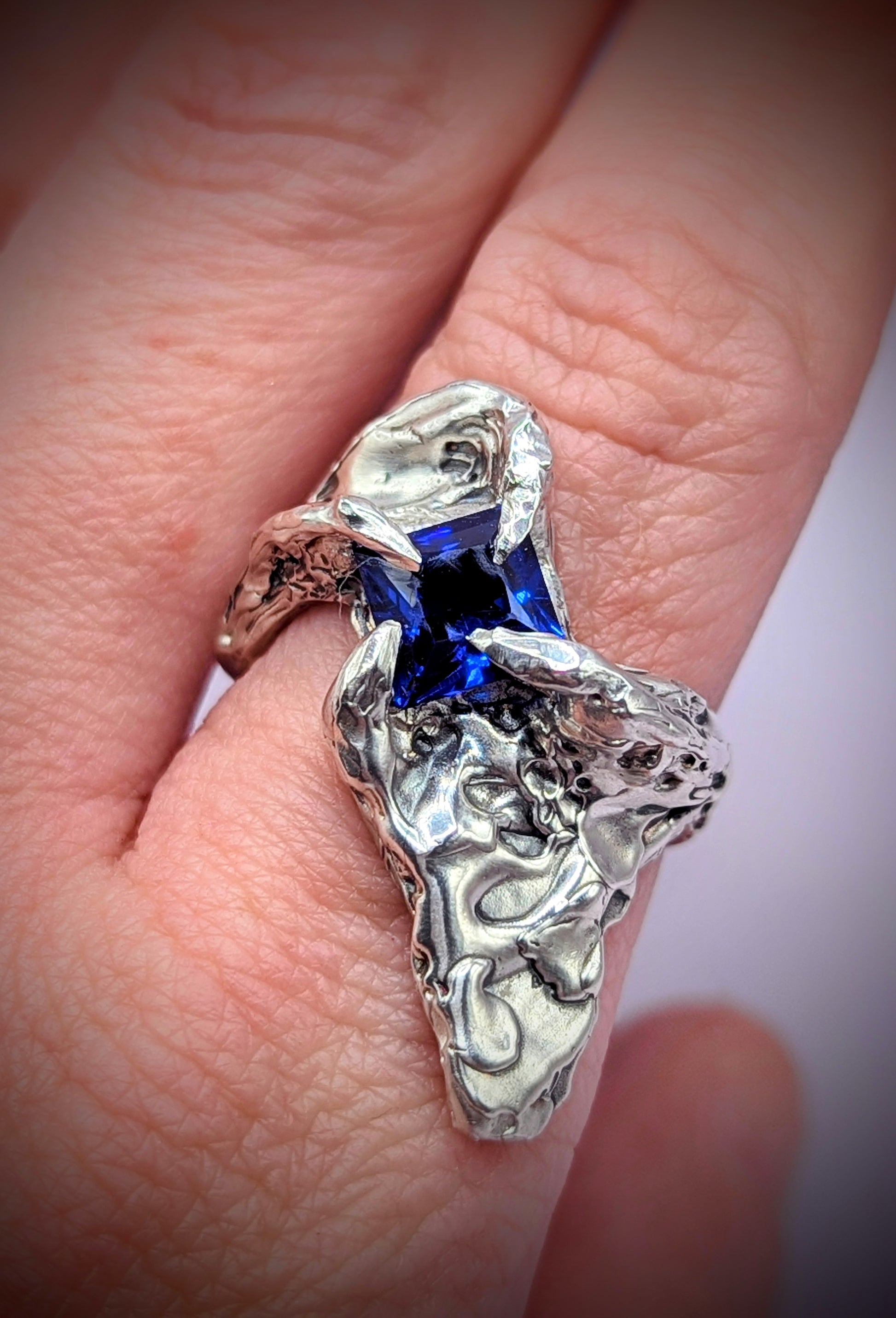 Chunky handmade silver ring with flowing form – deep blue gemstone centrepiece