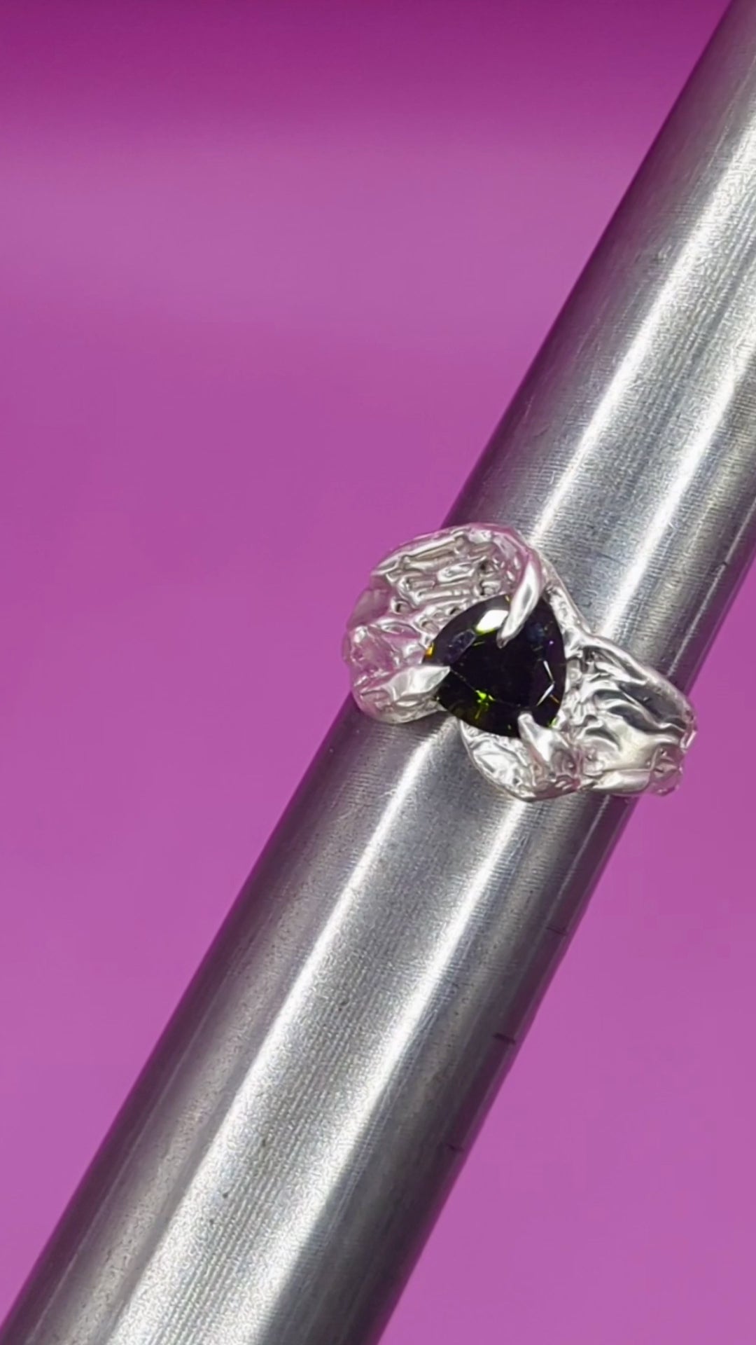 Close-up video of handmade silver ring on mandrel – claw detail and Peridot gemstone