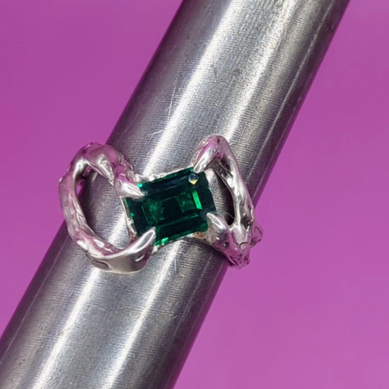 Close-up video of handmade silver ring on mandrel – emerald nano gem and twisted silver band