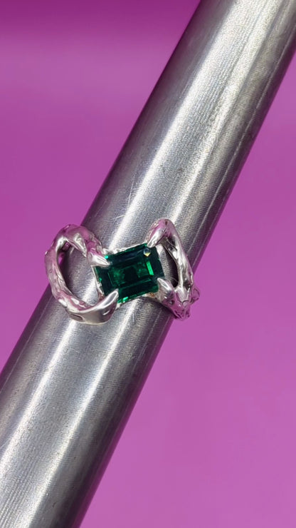 Close-up video of handmade silver ring on mandrel – emerald nano gem and twisted silver band