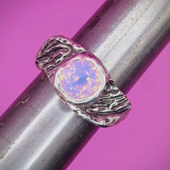 Close-up video of handmade silver ring on mandrel – feathered band with pink opal nano gem