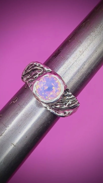 Close-up video of handmade silver ring on mandrel – feathered band with pink opal nano gem